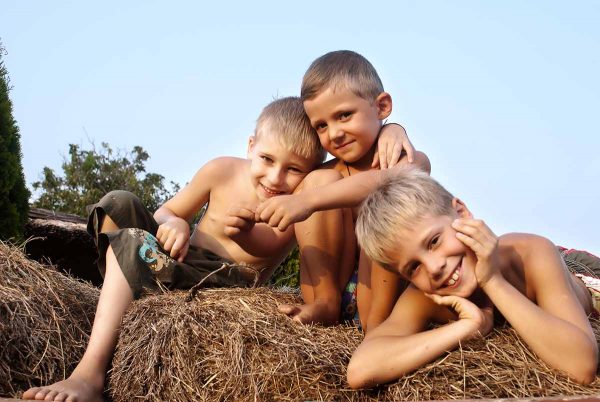 Children Laying On Hay Bale